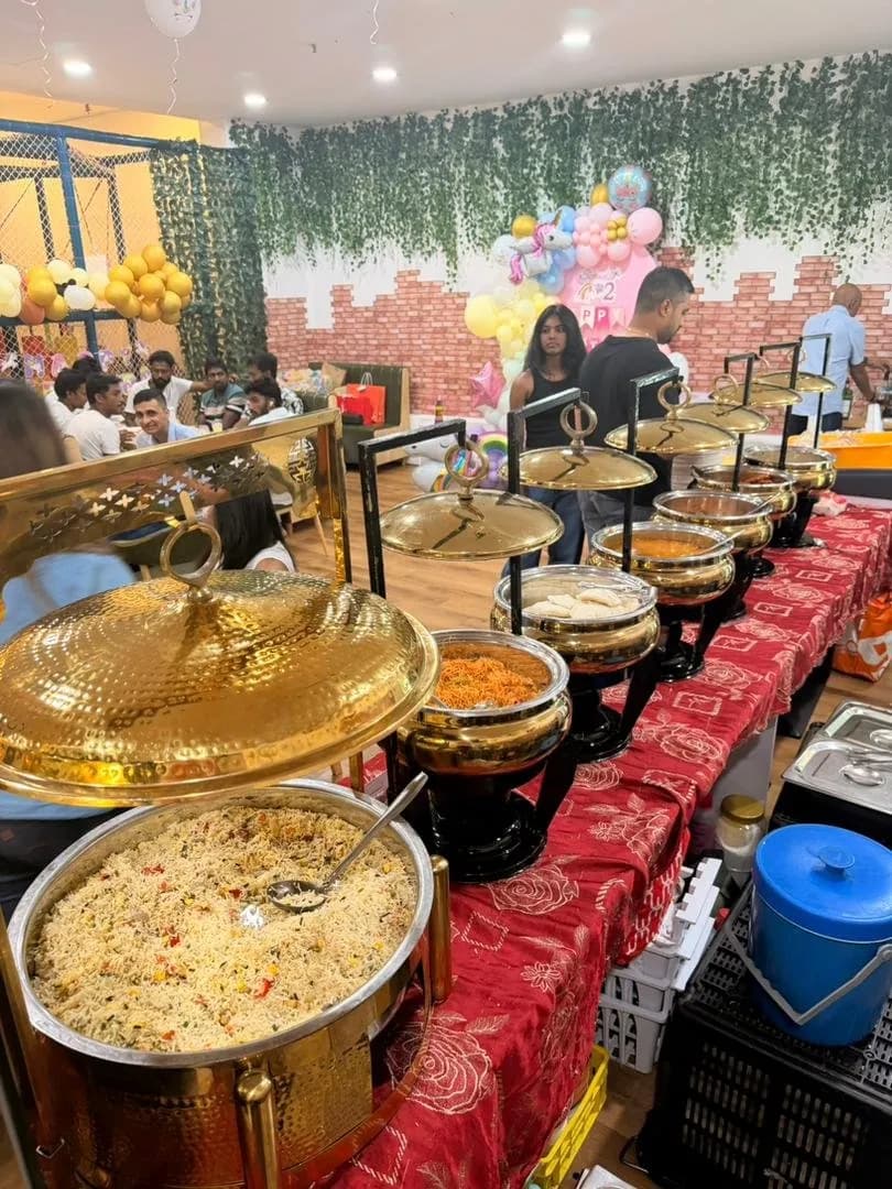 Party table set with food, plates and juice boxes at Play Kingdoms in Hartamas